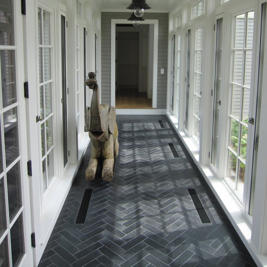 Black Herringbone Stone Floor Tiles In A Hallway.