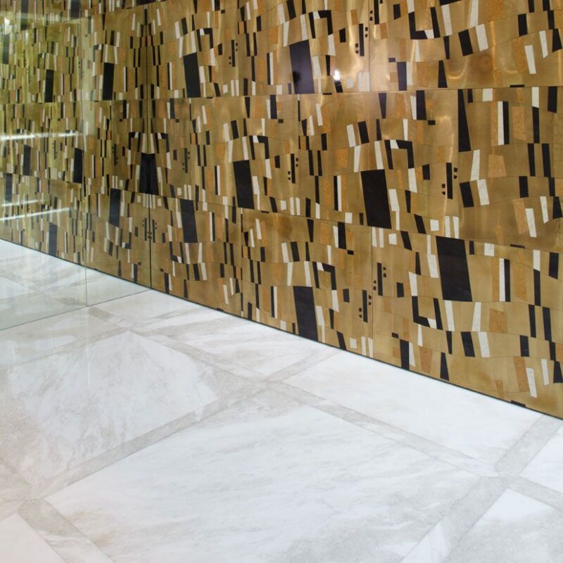 Lapicida Windhurst white marble flooring contrasts with Klimt wall design