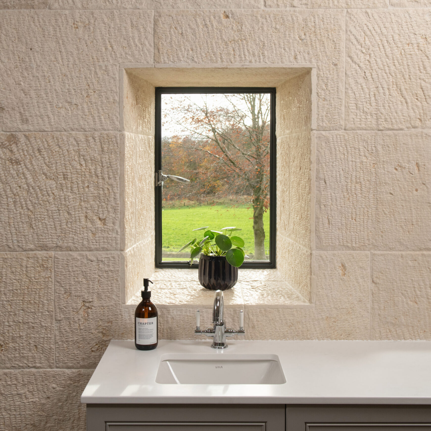 Lapicida Biblical Ivory wall surface brings an antique look, texture and tone to the bathroom at Danby Grange